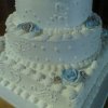 4 tier silver and blue cake 15 - 4 tiers with silver shimmer and blue airbrushing on the roses.7", 10", 13", round tiers on a 16" square. 35 pounds. Serves 175.